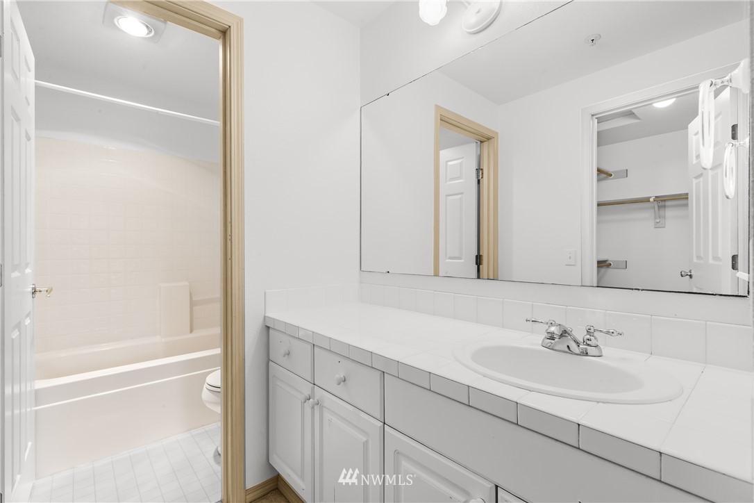 1160 Monroe Avenue Northeast, Unit A4 Renton, WA 98056 - Photo 15 of 26 a bathroom with a sink and a bathtub