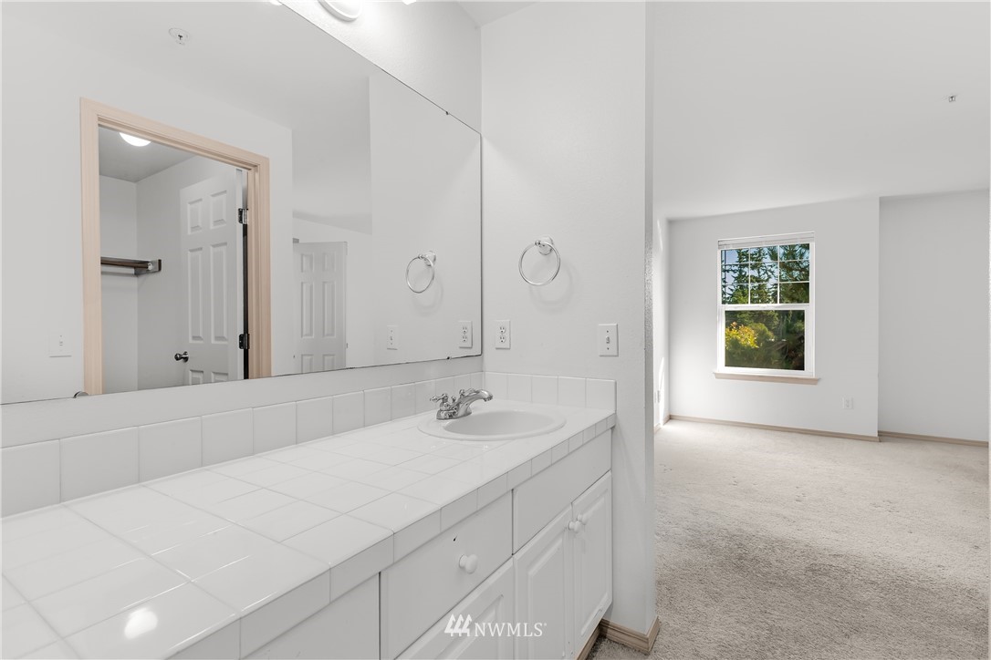 1160 Monroe Avenue Northeast, Unit A4 Renton, WA 98056 - Photo 17 of 26 a bathroom with a sink and a mirror