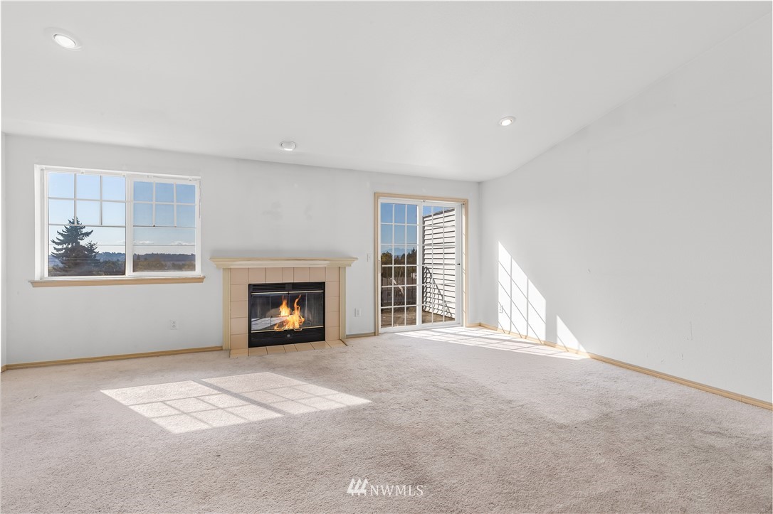 1160 Monroe Avenue Northeast, Unit A4 Renton, WA 98056 - Photo 6 of 26 a view of an empty room with a window and fireplace