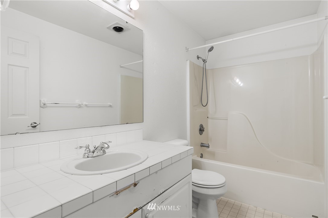 1160 Monroe Avenue Northeast, Unit A4 Renton, WA 98056 - Photo 9 of 26 a bathroom with a sink a toilet and shower