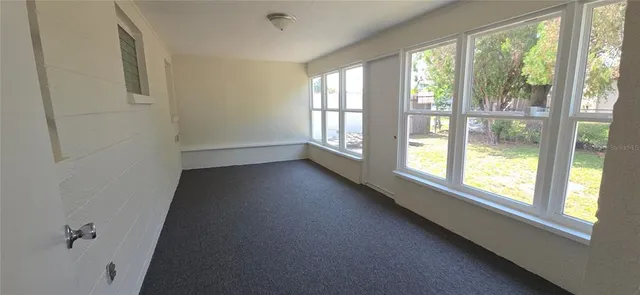 a view of a livingroom with an empty space and a window