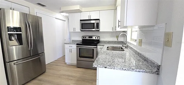 a kitchen with a refrigerator stove and microwave