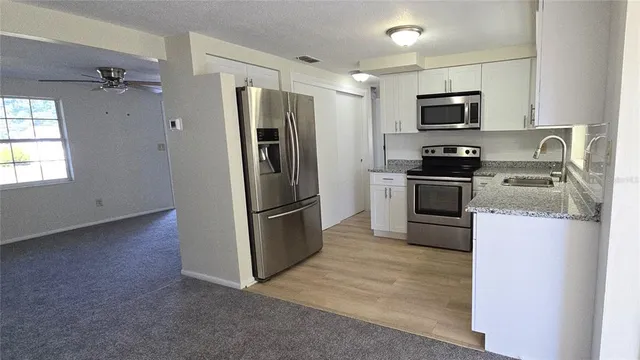 a kitchen with a refrigerator stove and microwave
