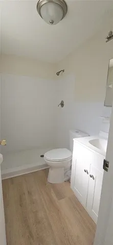 a white toilet sitting next to a bathroom sink