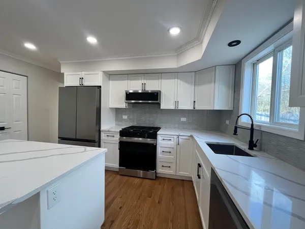 a kitchen with a sink stove and refrigerator