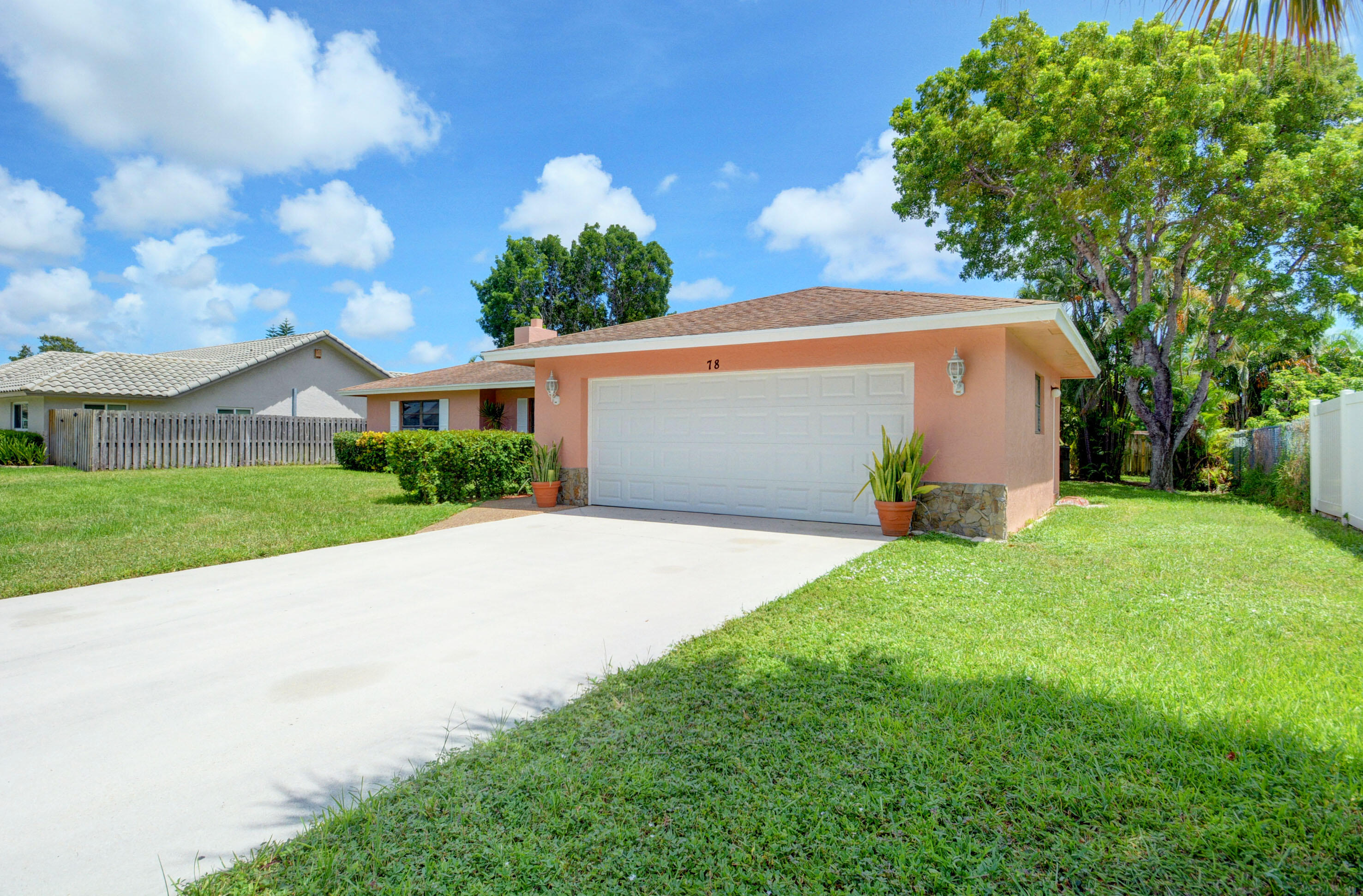 78 Southwest 12th Way Boca Raton, FL 33486 - Photo 1 of 34 a front view of house with garden