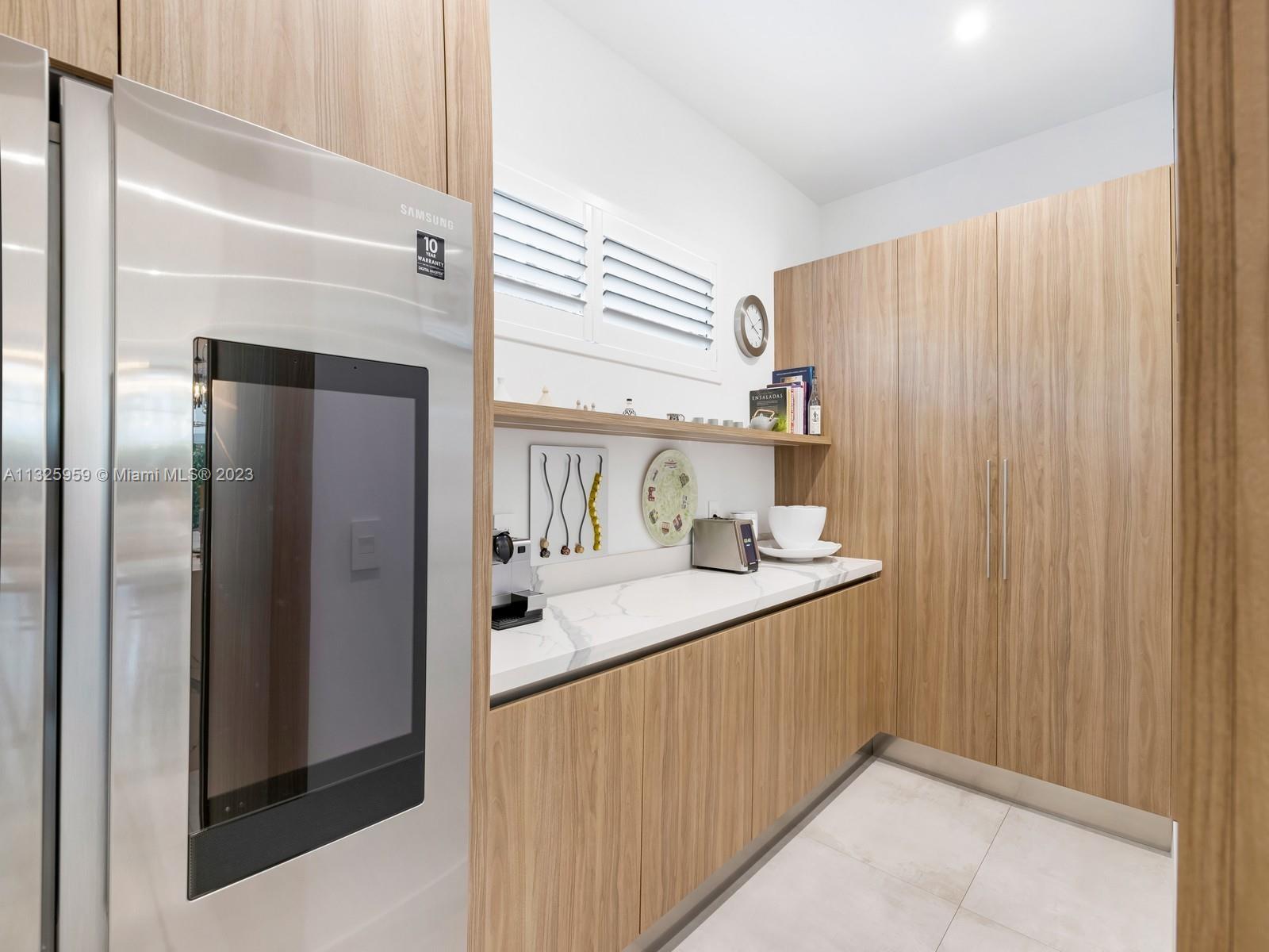 7260 School House Road Miami, FL 33143 - Photo 13 of 44 a kitchen with stainless steel appliances a sink and a refrigerator