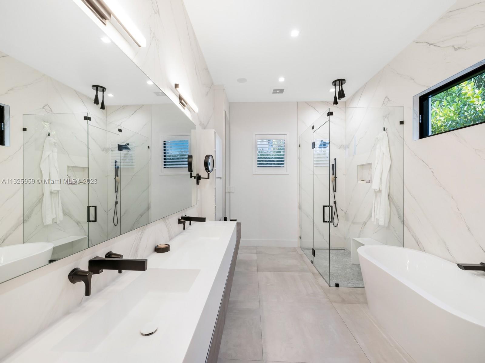 7260 School House Road Miami, FL 33143 - Photo 24 of 44 a bathroom with a tub sink shower and mirror