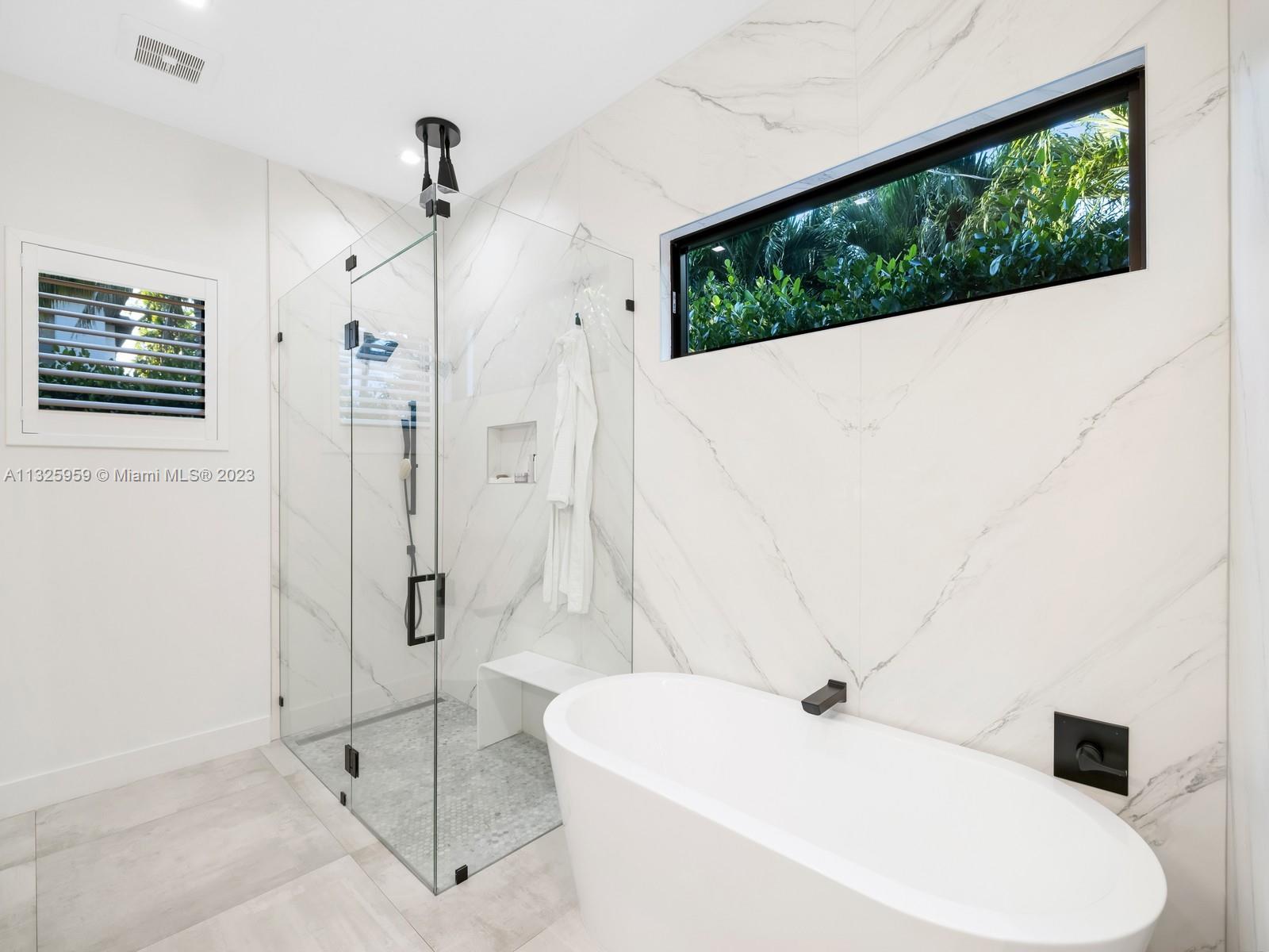 7260 School House Road Miami, FL 33143 - Photo 25 of 44 a bathroom with a bathtub and a shower