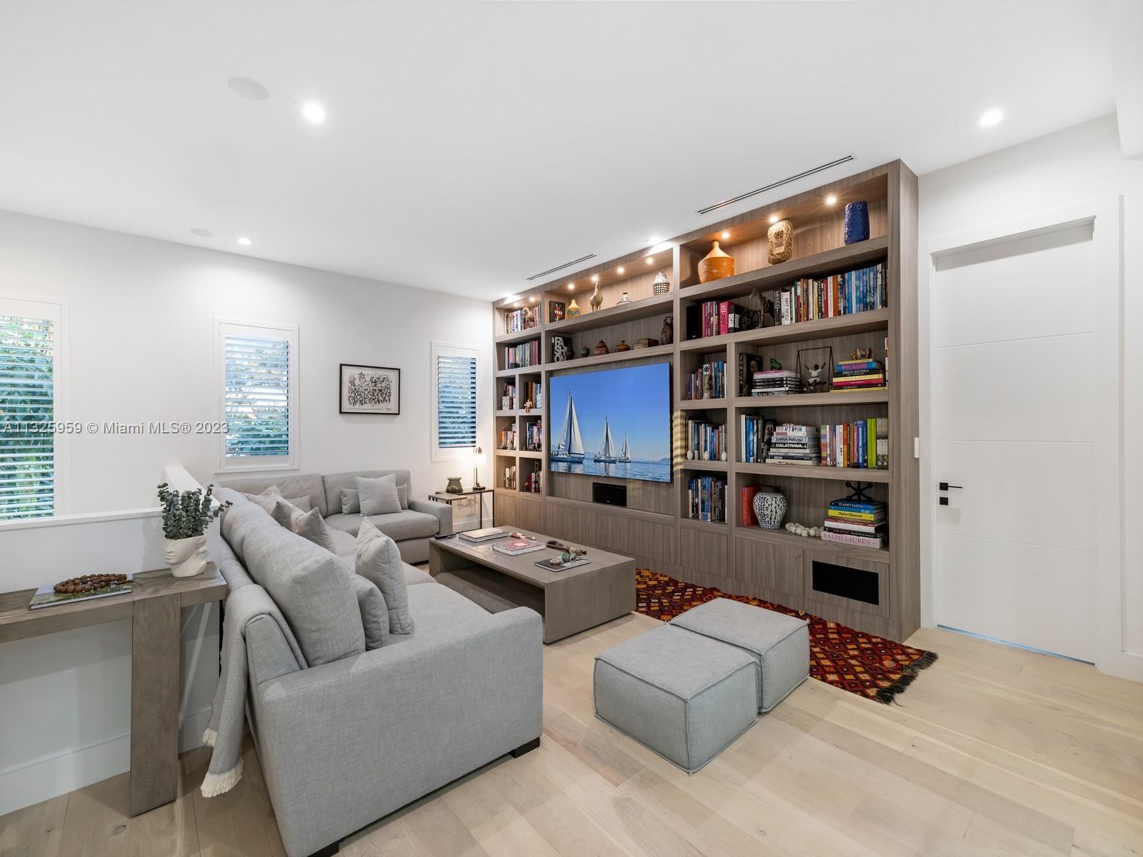 7260 School House Road Miami, FL 33143 - Photo 30 of 44 a living room with furniture and a book shelf