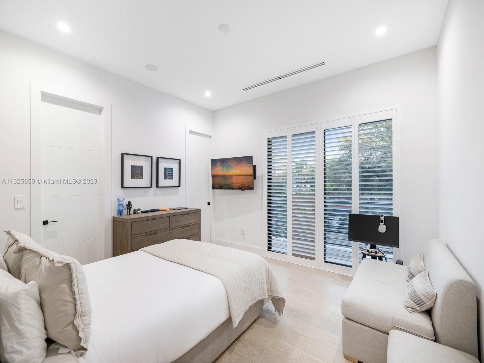 7260 School House Road Miami, FL 33143 - Photo 33 of 44 a bedroom with a bed and wooden floor