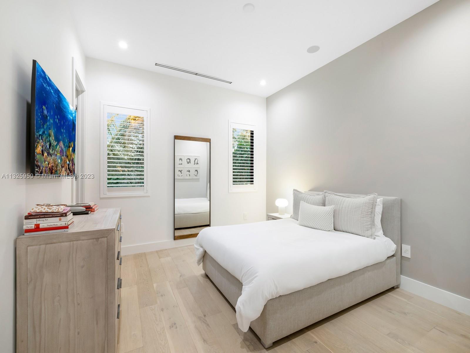 7260 School House Road Miami, FL 33143 - Photo 35 of 44 a bedroom with a bed and a flat screen tv