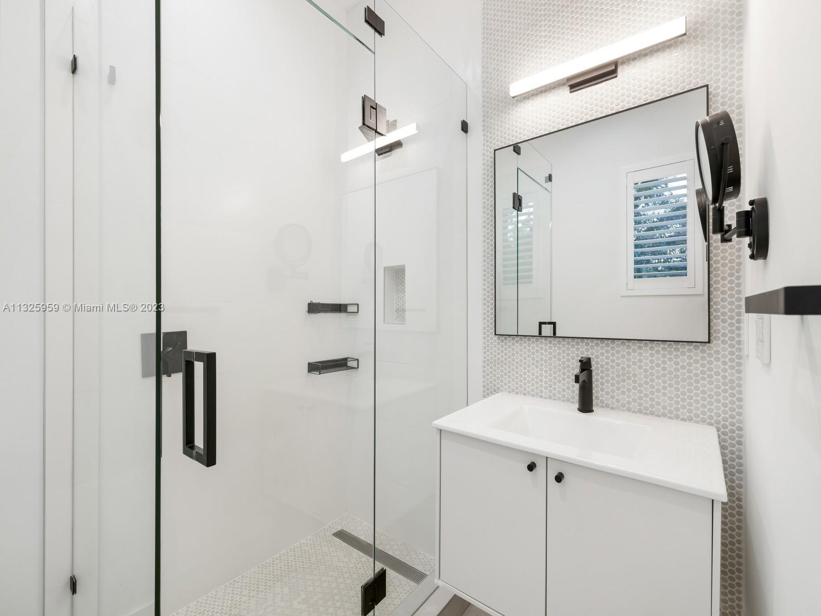 7260 School House Road Miami, FL 33143 - Photo 37 of 44 a bathroom with a sink and mirror