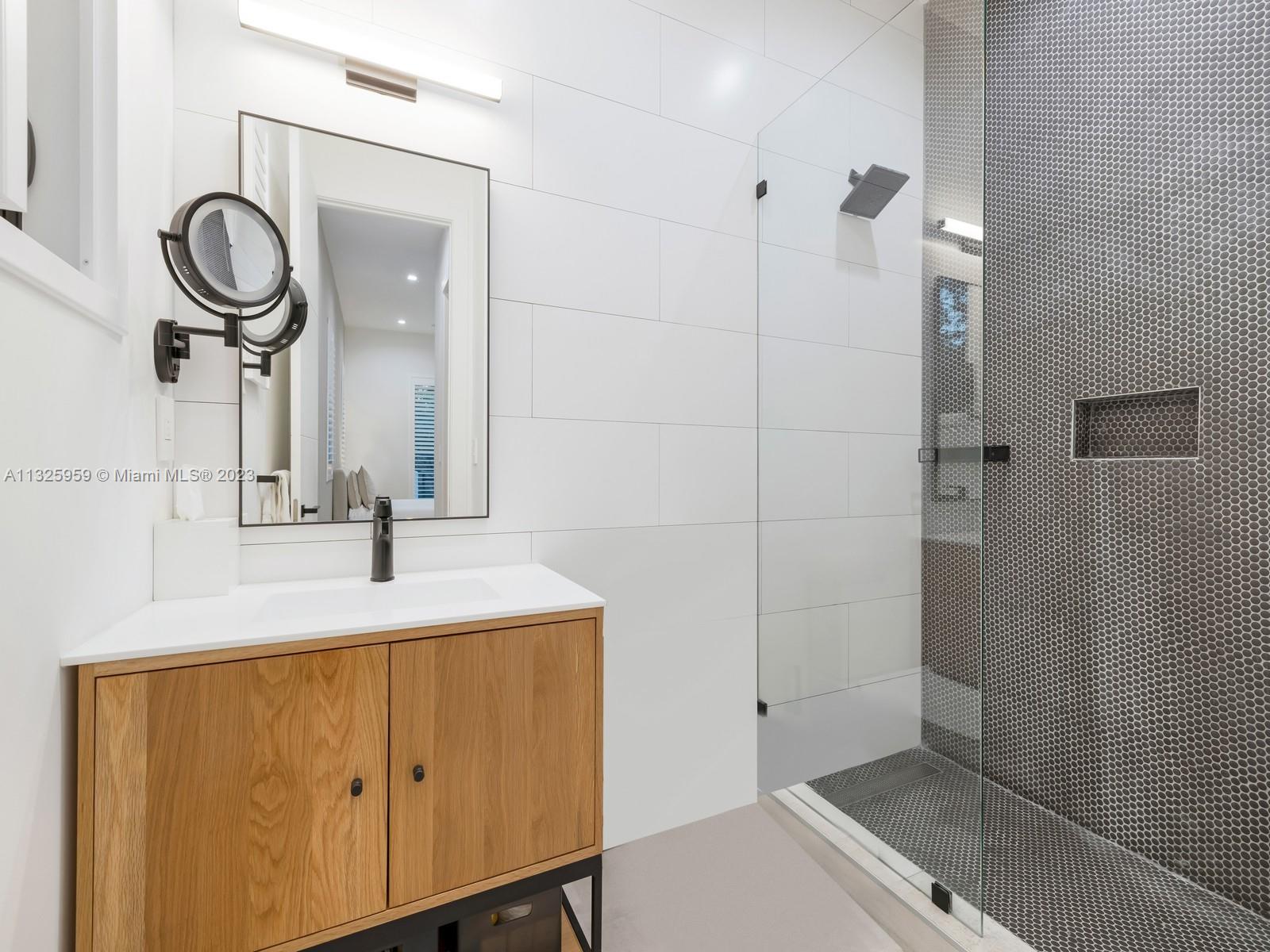 7260 School House Road Miami, FL 33143 - Photo 40 of 44 a bathroom with a sink and a mirror