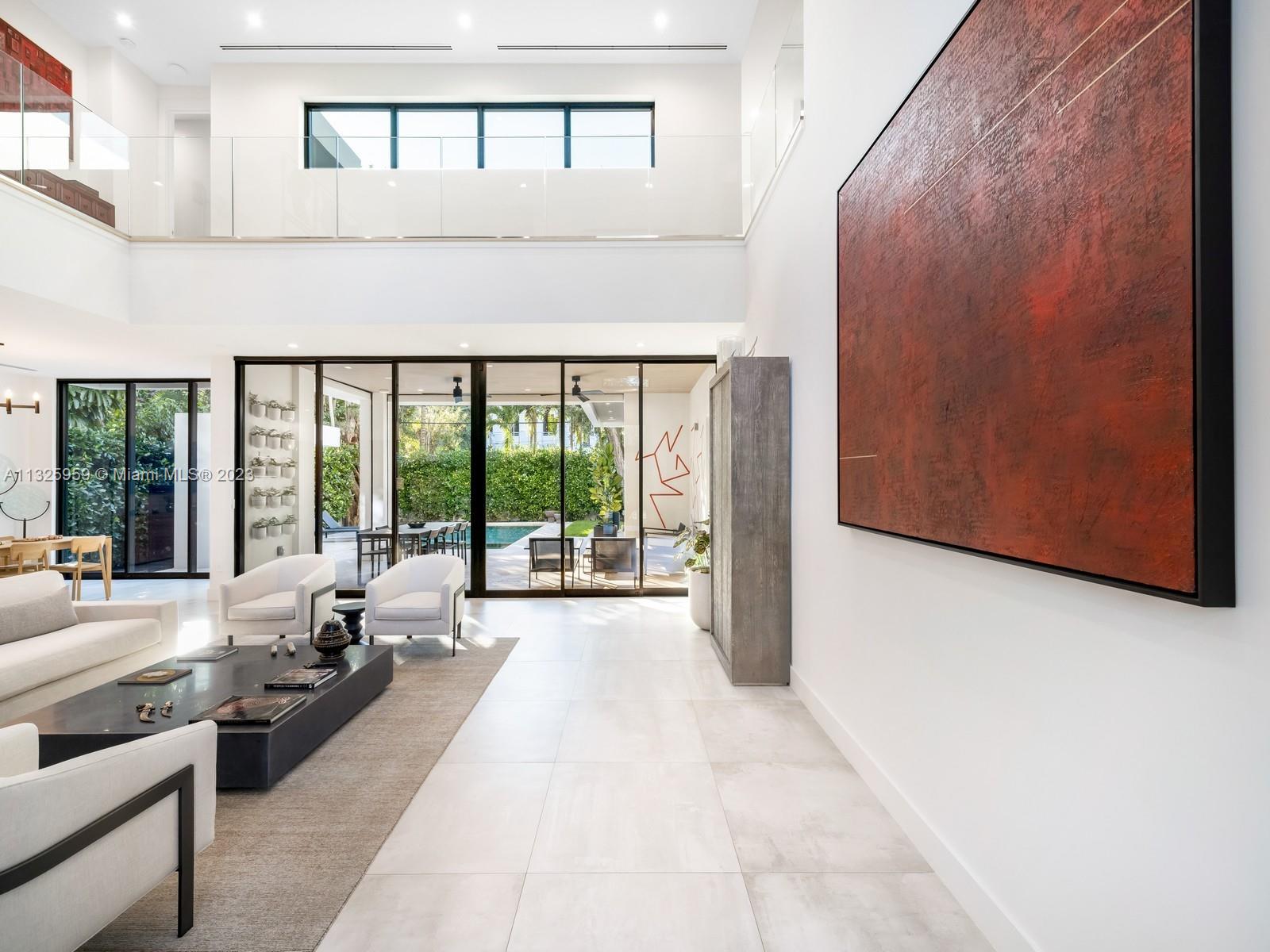 7260 School House Road Miami, FL 33143 - Photo 4 of 44 a large white building with a large window and yard