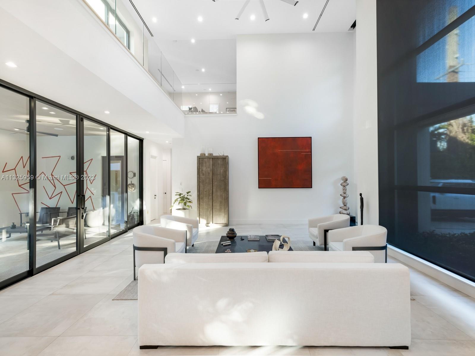 7260 School House Road Miami, FL 33143 - Photo 7 of 44 a living room with furniture and a floor to ceiling window