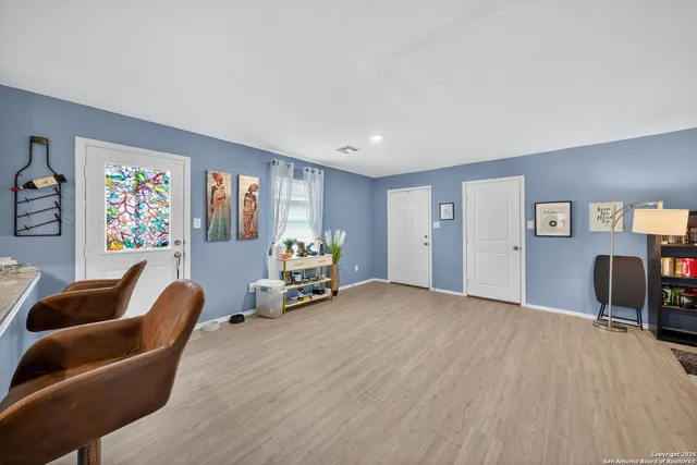 a bedroom with furniture and a chair