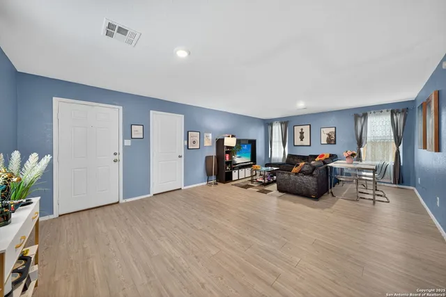 a bed room with furniture and a wooden floor