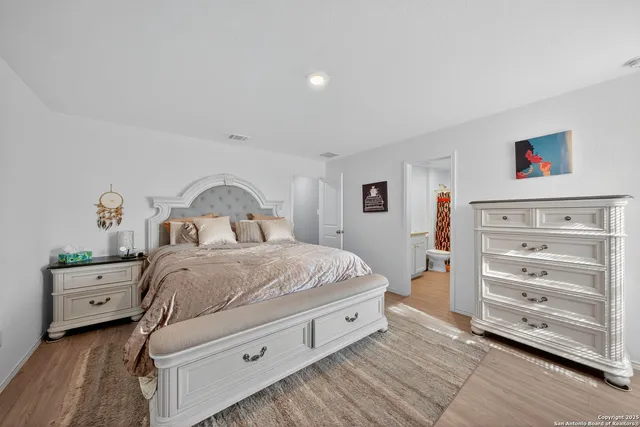 a bedroom with a bed and a dresser