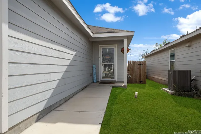 a view of a backyard with potted plants
