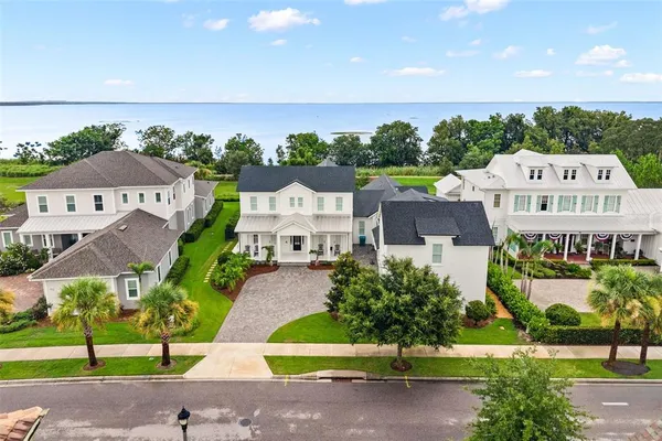 an aerial view of a house with a garden and trees