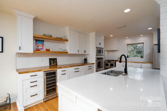 a kitchen with counter top space cabinets and appliances