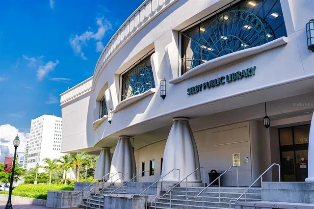 a front view of a house with a yard and potted plants
