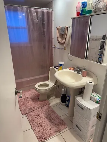 a bathroom with a sink toilet and a mirror
