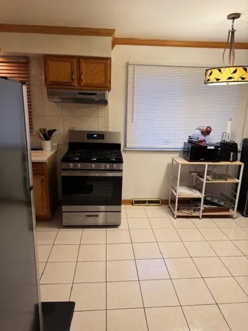 a kitchen with granite countertop a stove a sink and a microwave