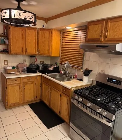 a kitchen with a sink stove and cabinets