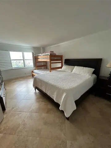 a bedroom with bed and window