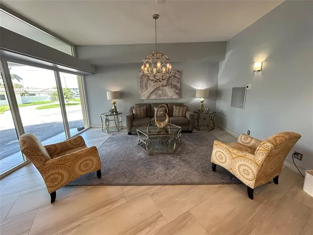 a living room with furniture and a chandelier