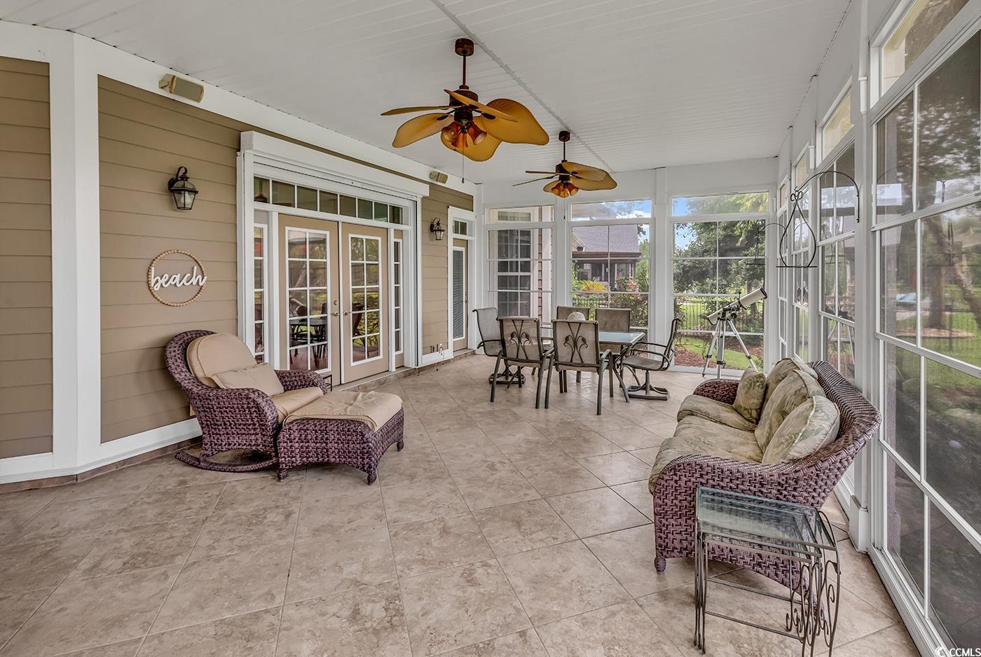 7029 Byrnes Lane Myrtle Beach, SC 29588 - Photo 16 of 40 Sunroom / solarium featuring french doors, ceiling fan, and outdoor dining space