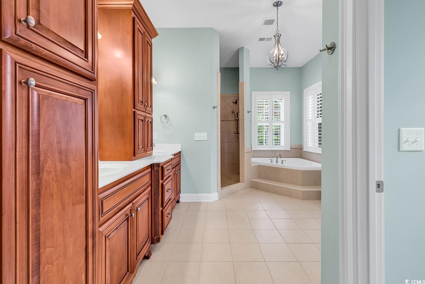 7029 Byrnes Lane Myrtle Beach, SC 29588 - Photo 21 of 40 Full bathroom with a stall shower, a garden tub, double vanity, and tile patterned flooring