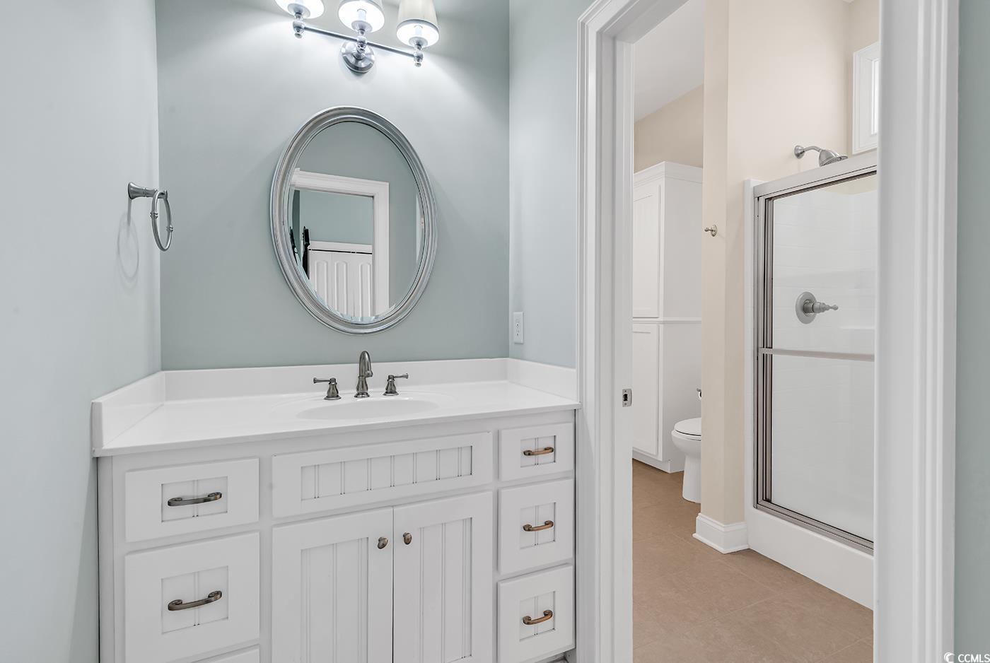 7029 Byrnes Lane Myrtle Beach, SC 29588 - Photo 27 of 40 Bathroom featuring a stall shower and vanity