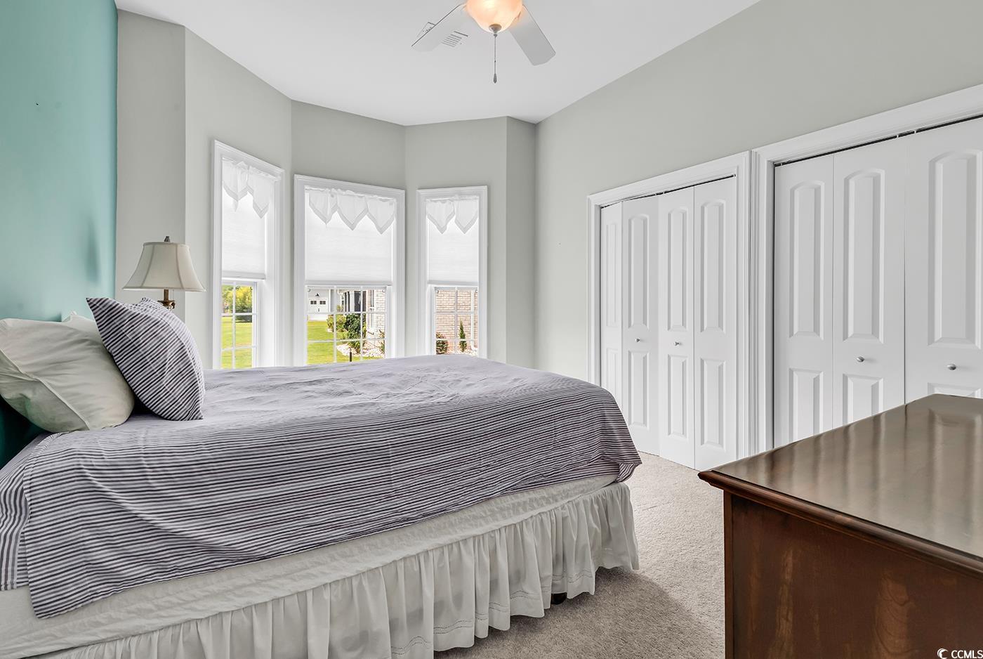 7029 Byrnes Lane Myrtle Beach, SC 29588 - Photo 28 of 40 Bedroom with carpet, multiple closets, and a ceiling fan