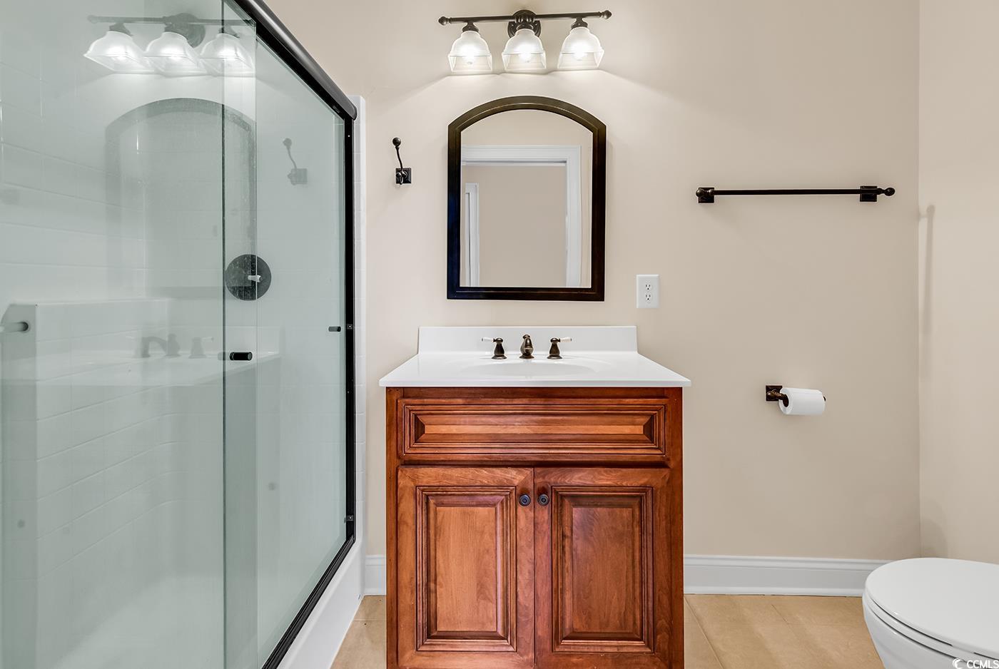 7029 Byrnes Lane Myrtle Beach, SC 29588 - Photo 34 of 40 Bathroom featuring a stall shower, vanity, and tile patterned floors
