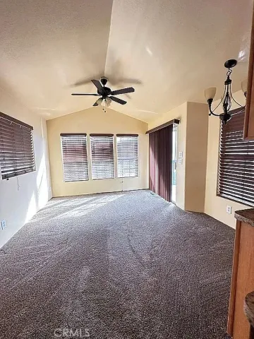 a view of a livingroom with a ceiling fan and window
