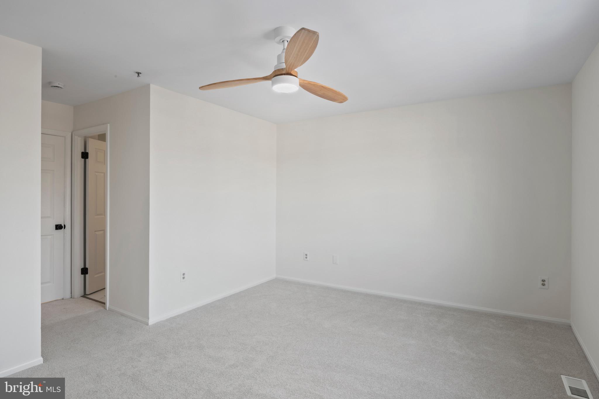 6412 Wind Rider Way Columbia, MD 21045 - Photo 11 of 37 an empty room with a ceiling fan and a window
