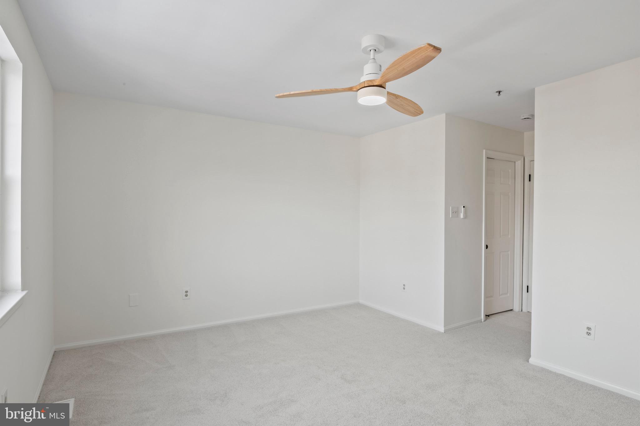 6412 Wind Rider Way Columbia, MD 21045 - Photo 12 of 37 a view of a room with stairs and a ceiling fan