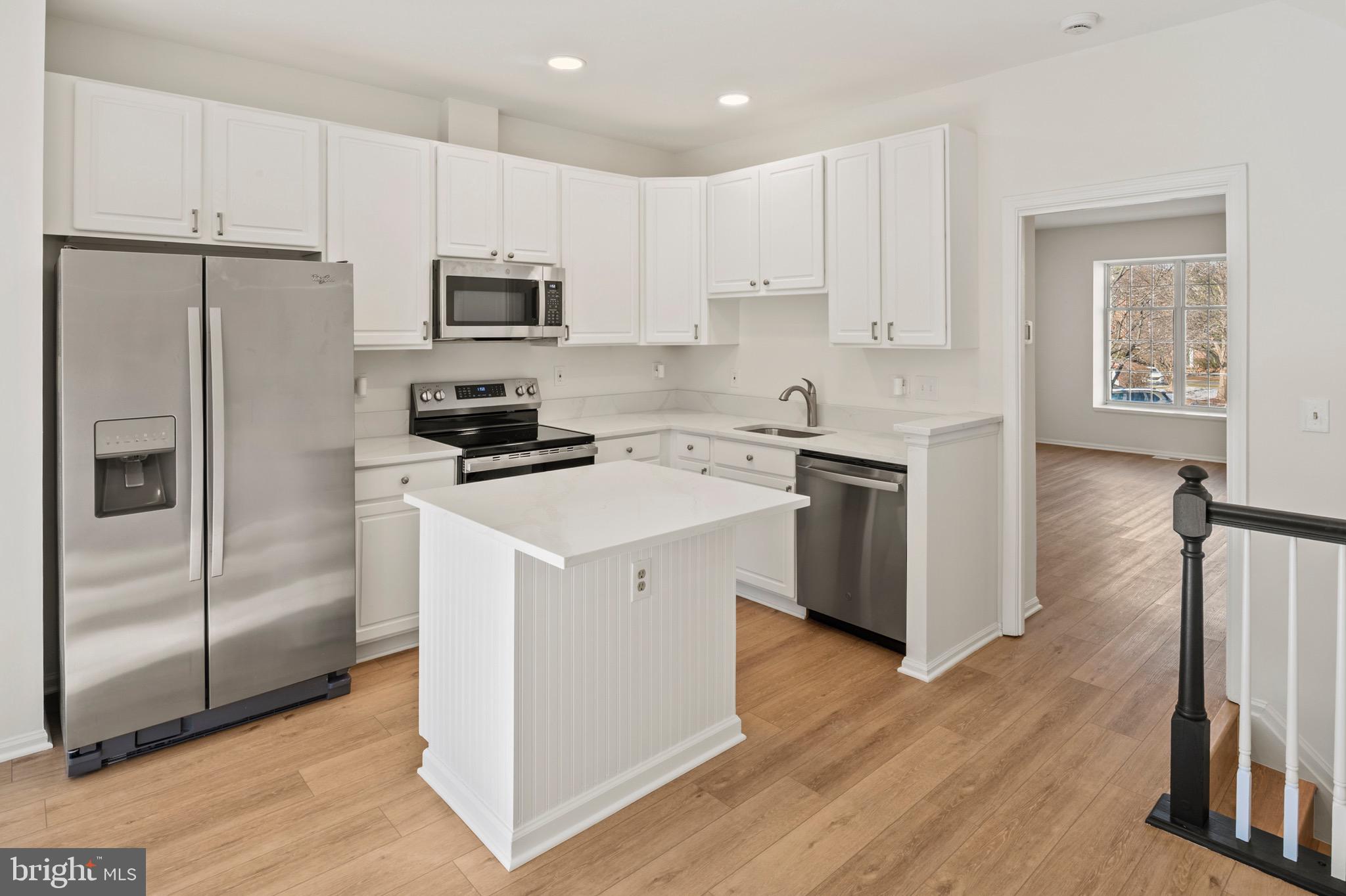 6412 Wind Rider Way Columbia, MD 21045 - Photo 2 of 37 a kitchen with white cabinets stainless steel appliances and a refrigerator