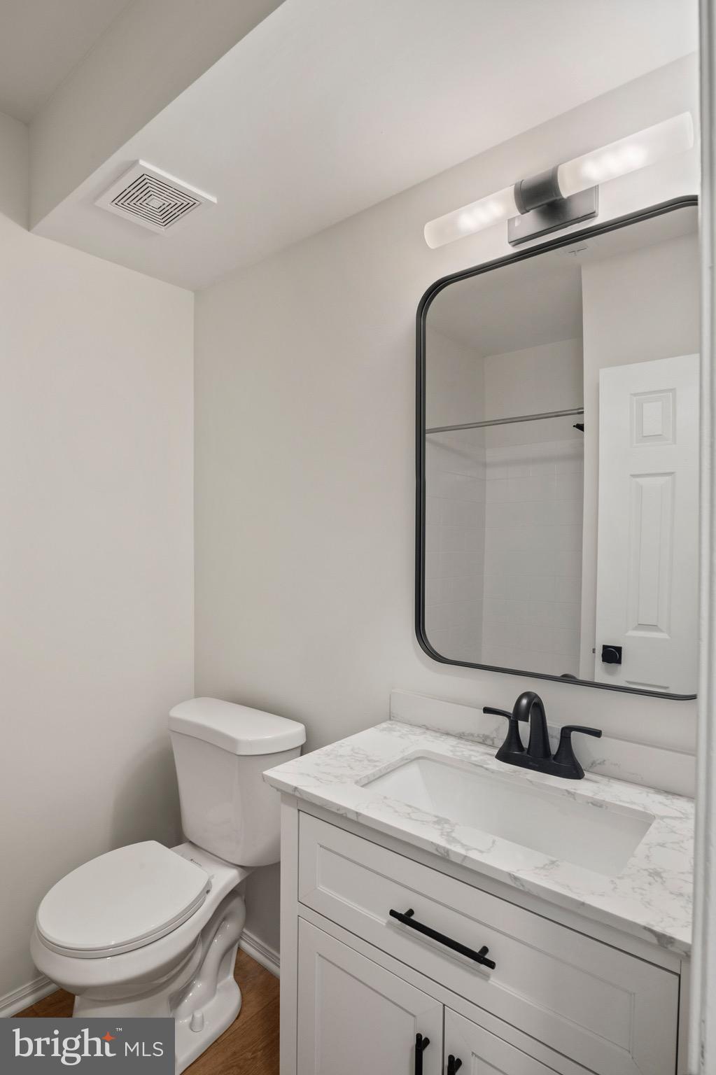 6412 Wind Rider Way Columbia, MD 21045 - Photo 26 of 37 a bathroom with a toilet a sink and mirror
