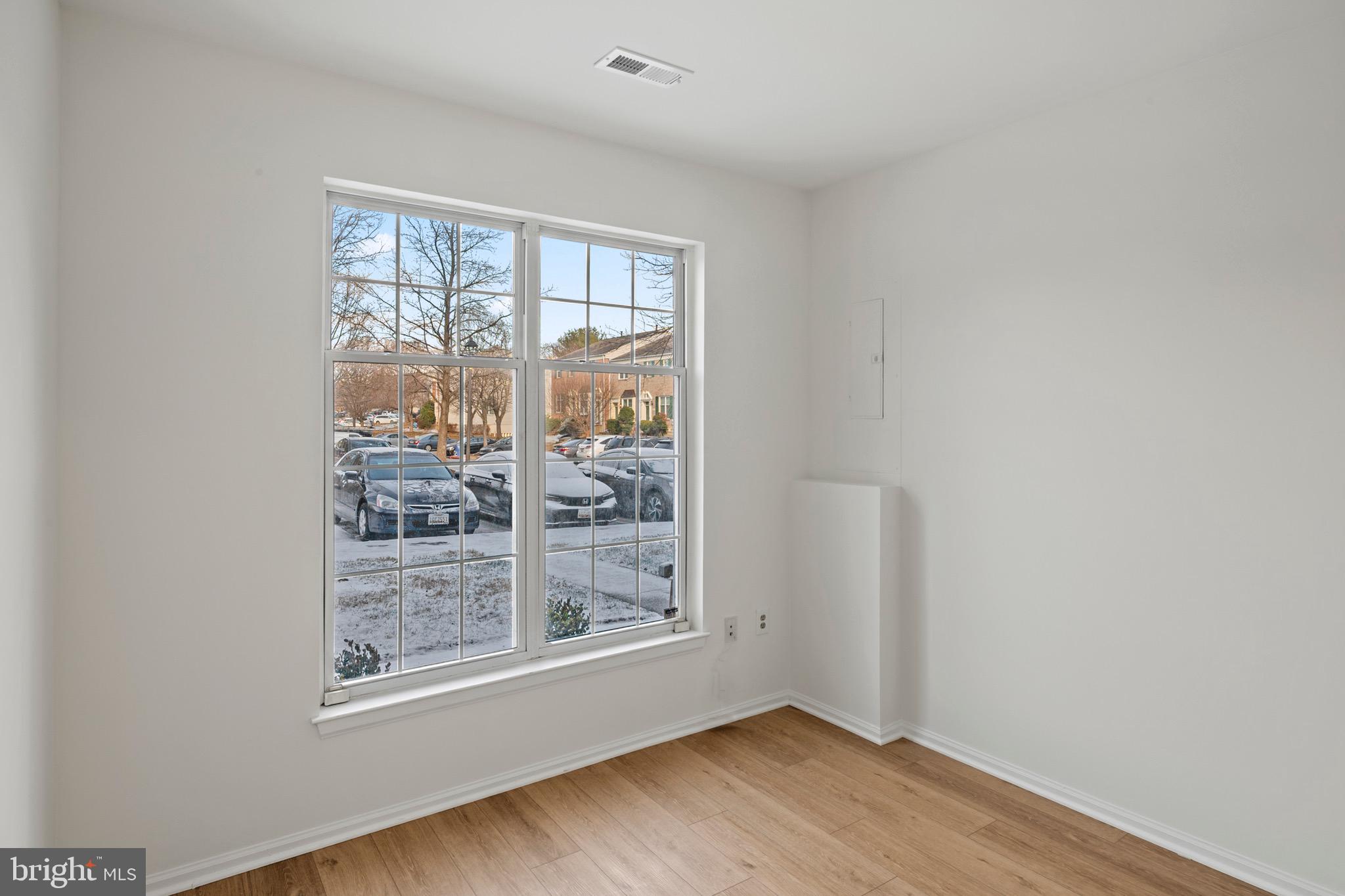6412 Wind Rider Way Columbia, MD 21045 - Photo 28 of 37 an empty room with wooden floor and windows