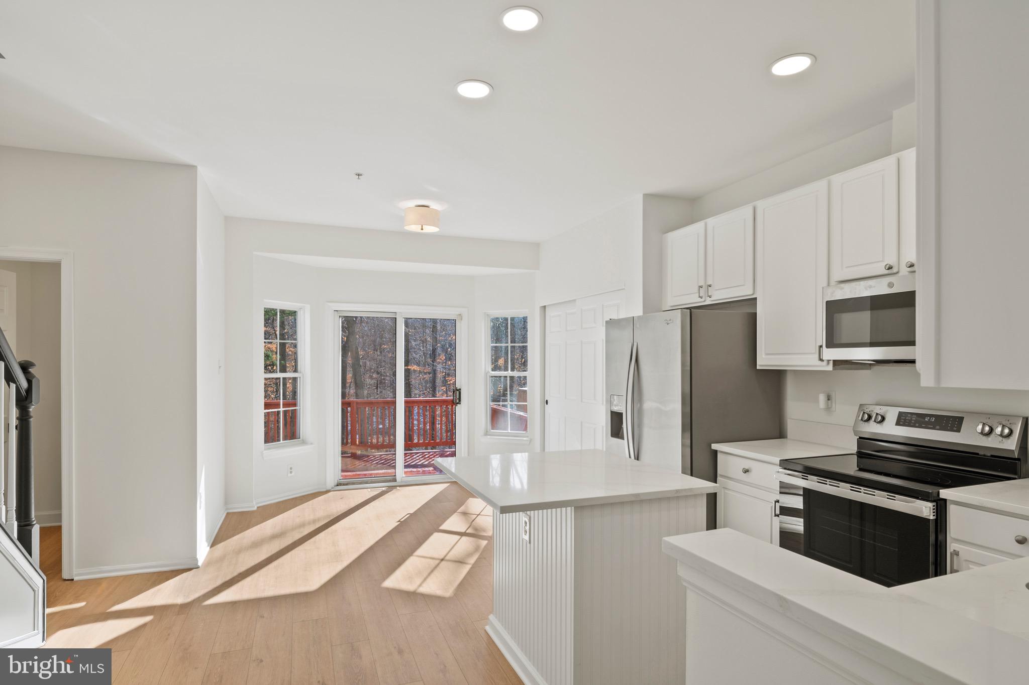 6412 Wind Rider Way Columbia, MD 21045 - Photo 5 of 37 a kitchen that has a refrigerator a stove and white cabinets