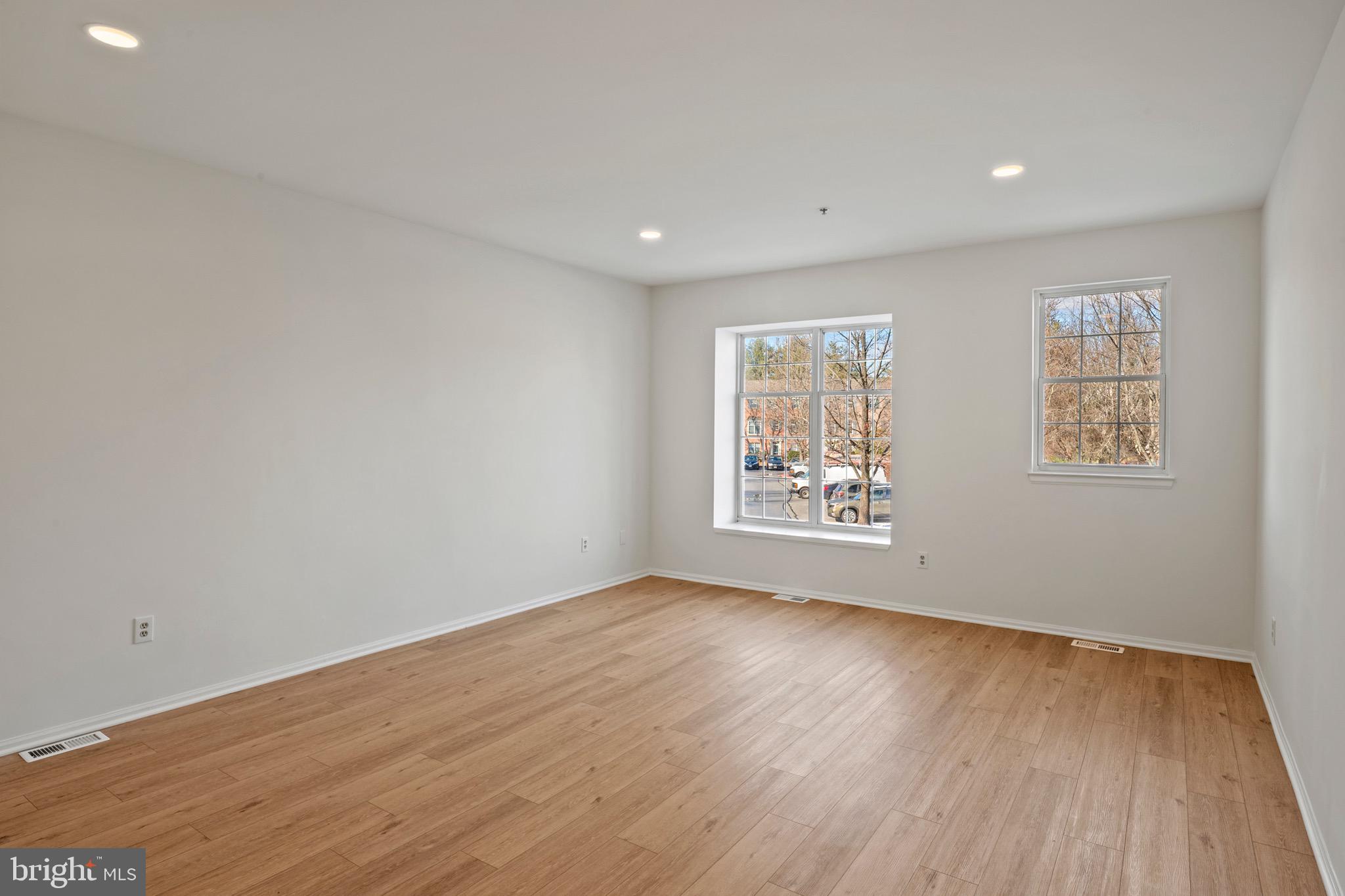 6412 Wind Rider Way Columbia, MD 21045 - Photo 8 of 37 a view of an empty room with wooden floor and a window