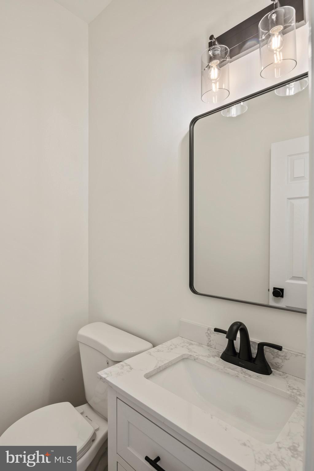 6412 Wind Rider Way Columbia, MD 21045 - Photo 10 of 37 a bathroom with a toilet sink and mirror