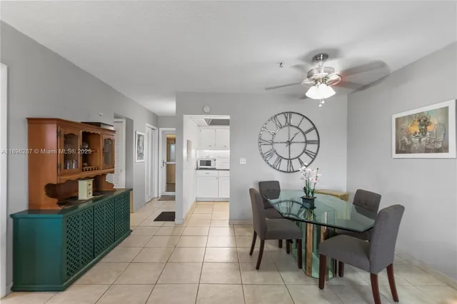 a view of a dining room with furniture and a chandelier