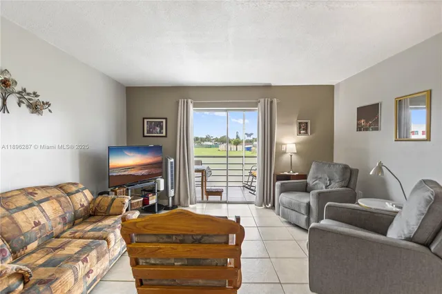 a bedroom with furniture and a flat screen tv