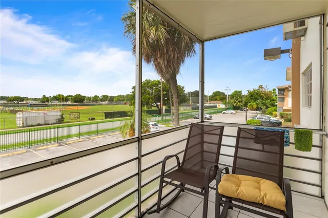 a view of swimming pool with outdoor seating and city view