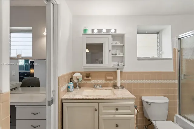 a bathroom with a toilet sink and mirror
